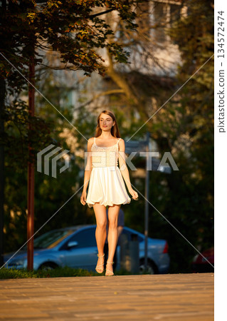 Slavic Woman Walking in Warm Golden Light Slavic Woman Walking in Warm Golden Light 134572474
