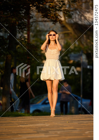 Slavic Woman Walking in Warm Golden Light Slavic Woman Walking in Warm Golden Light 134572475