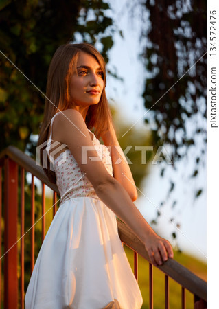 Slavic Woman in White Dress on Staircase 134572476