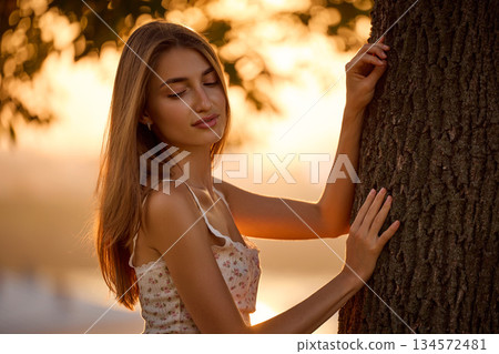 Slavic Woman in Lace Dress by Tree 134572481