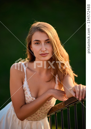 Slavic Woman in White Dress by Railing Slavic Woman in White Dress by Railing 134572488