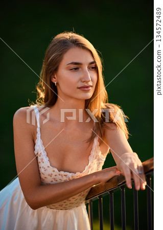 Slavic Woman in White Dress by Railing Slavic Woman in White Dress by Railing 134572489