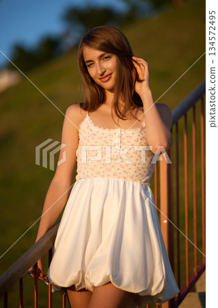 Slavic Woman in White Dress on Staircase Slavic Woman in White Dress on Staircase 134572495