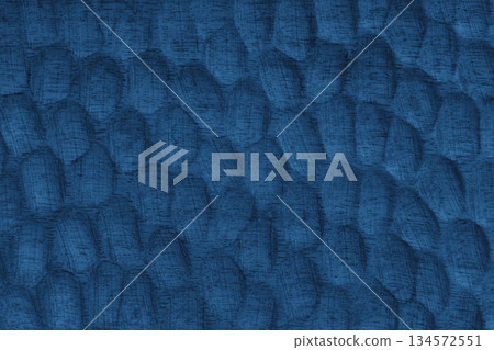 Blue painted wooden surface with carved texture pattern and natural wood grain background 134572551