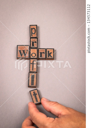 Work and Profit Concept with Wooden Letter Blocks on Gray Background Work and Profit Concept with Wooden Letter Blocks on Gray Background 134573112