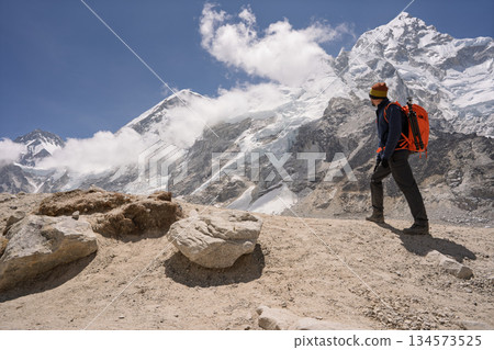 Hiker admiring Mount Nuptse peak on Everest Base Camp trek, Nepal 134573525