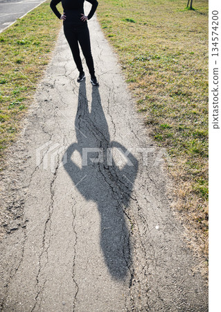 Body of woman projecting her shadow on path expressing Loneliness and Challenges Body of woman projecting her shadow on path expressing Loneliness and Challenges 134574200