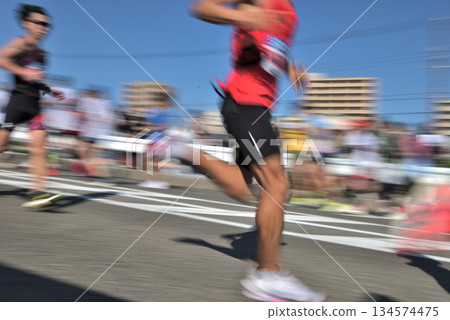 Marathon: Marathon runners running up a hill with slow shutter Marathon: Marathon runners running up a hill with slow shutter 134574475