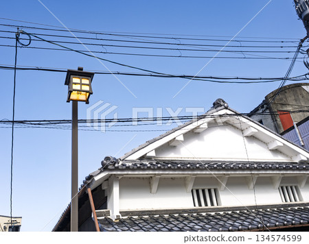 Retro street lamps and white-walled houses under the blue sky Retro street lamps and white-walled houses under the blue sky 134574599