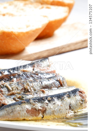 Sardines in Oil and Baguette - Sardines marinated in olive oil and freshly baked baguette Sardines in Oil and Baguette - Sardines marinated in olive oil and freshly baked baguette 134575107