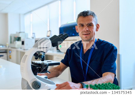 Scientist examining samples in modern laboratory with advanced equipment during working hours Scientist examining samples in modern laboratory with advanced equipment during working hours 134575345