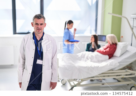 Healthcare professionals assist patients in a modern hospital setting during a busy daytime period Healthcare professionals assist patients in a modern hospital setting during a busy daytime period 134575412