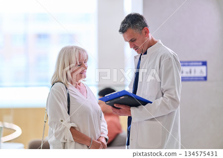 Doctor discusses treatment options with patient in a modern clinic setting during daylight Doctor discusses treatment options with patient in a modern clinic setting during daylight 134575431