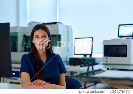 Medical professional in a modern laboratory setting during daylight hours focusing on patient care and lab technology 134575673