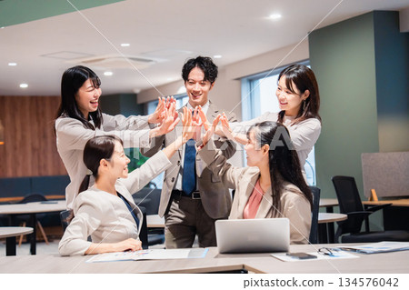 High-fiving with all office members High-fiving with all office members 134576042