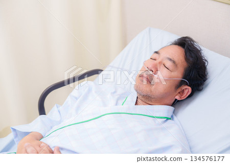 Elderly male hospitalized patient with a nasal tube 134576177