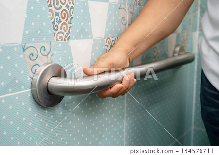 Asian elderly woman use toilet bathroom handle security, healthy strong medical. 134576711