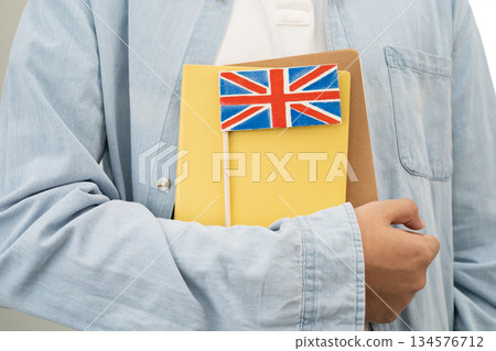 Learn English language, Asian teenage student hold book with flag in course at school. 134576712
