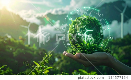 A person's hand holding a green planet globe represents a global business concept focused on environment, ecology, and nature within a digital communication network A person's hand holding a green planet globe represents a global business concept focused on environment, ecology, and nature within a digital communication network 134577134