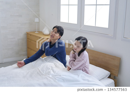 Couple waking up tired Couple waking up tired 134577563