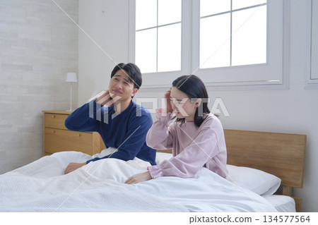 Couple waking up tired Couple waking up tired 134577564