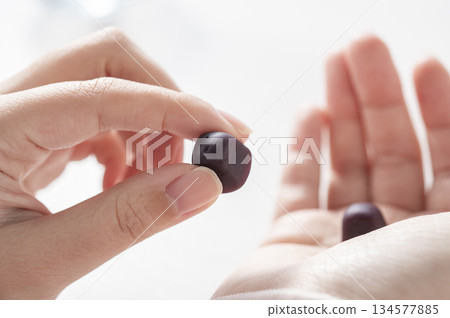 Woman's hand holding gummy supplements Woman's hand holding gummy supplements 134577885