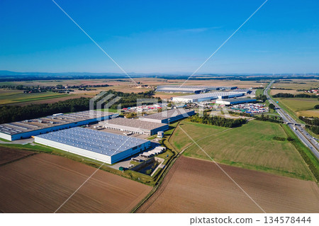 Aerial view of large logistics and warehouse complex in rural area Aerial view of large logistics and warehouse complex in rural area 134578444