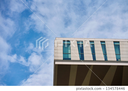 Modern office building facade against blue sky Modern office building facade against blue sky 134578446