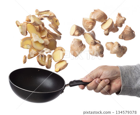 Galangal mix Ginger fall fly in pan, fresh vegetable spice ginger galangal falling. Organic fresh herbal ginger galangal root head cut chop slice. White background isolated freeze motion high speed 134579378