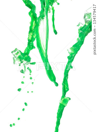 Green Matcha Milk Tea pour fall down, explosion in air with ice cube cold. Green Matcha Milk Tea spill splash in shape form line as paint color. White background isolated high speed shutter freeze 134579417