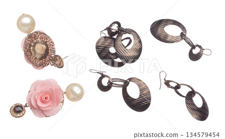 Fashion pearl Earrings with beautiful work detail is value. Luxury deep sea pearl diamond earring is fashion trend and fly in air. White background isolated 134579454