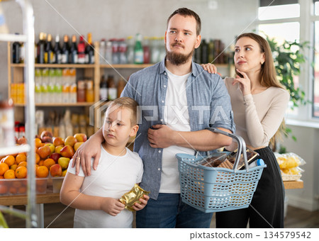 Friendly family shopping for groceries in supermarket 134579542