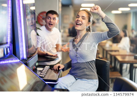 Young woman won at slot machine in cafe 134579974