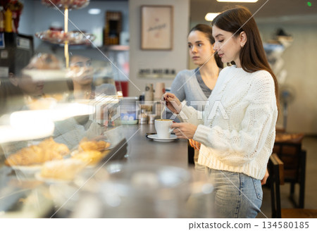 Two female friends met in a cafe 134580185