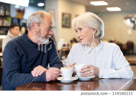 Couple of men and women talking and drinking coffee Couple of men and women talking and drinking coffee 134580215