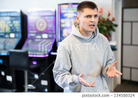 Portrait of frustrated man who lost money on slot machines 134580324