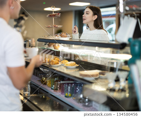 Young woman ordering at the counter in a cafe 134580456