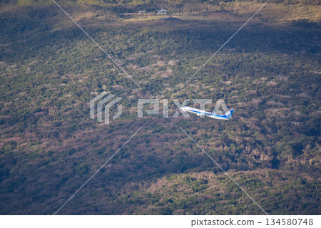 A passenger plane takes off over the natural beauty of Hachijojima. The skyline seen from the Osaka Tunnel Observatory. 134580748