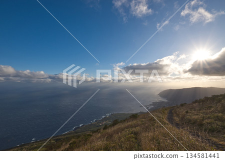 The Pacific Ocean and sunrise seen from the trailhead of Hachijo-Fuji: An open morning scene with blue skies and a wide horizon The Pacific Ocean and sunrise seen from the trailhead of Hachijo-Fuji: An open morning scene with blue skies and a wide horizon 134581441