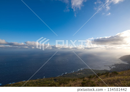 A morning view of the Pacific Ocean from the Hachijo Fuji trailhead: A tranquil natural landscape with blue skies and a horizon A morning view of the Pacific Ocean from the Hachijo Fuji trailhead: A tranquil natural landscape with blue skies and a horizon 134581442