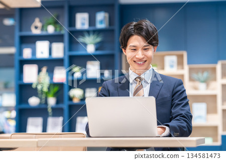 A young businessman working in the office 134581473