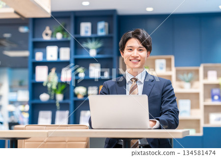 A young businessman working in the office 134581474