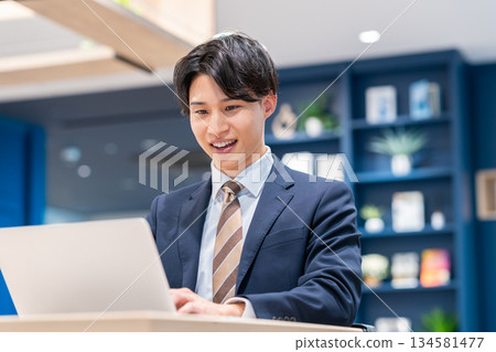 A young businessman working in the office 134581477