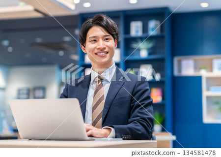 A young businessman working in the office 134581478