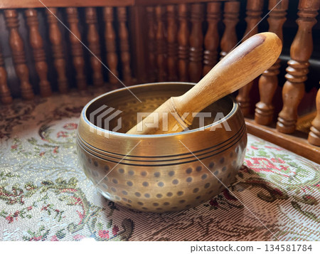 brass singing bowls arranged on soft white fabric, sound bath, A peaceful, spiritual composition symbolizing sound healing, meditation, and mindful balance in holistic wellness practice 134581784