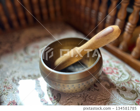 brass singing bowls arranged on soft white fabric, sound bath, A peaceful, spiritual composition symbolizing sound healing, meditation, and mindful balance in holistic wellness practice 134581785