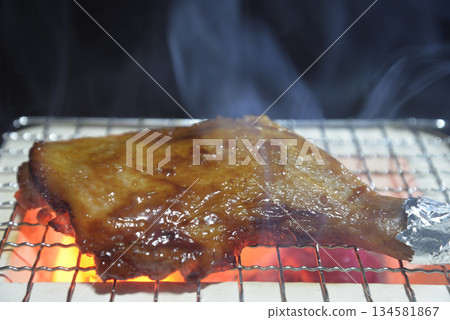 Grilling chicken thighs on a smoky charcoal grill Grilling chicken thighs on a smoky charcoal grill 134581867