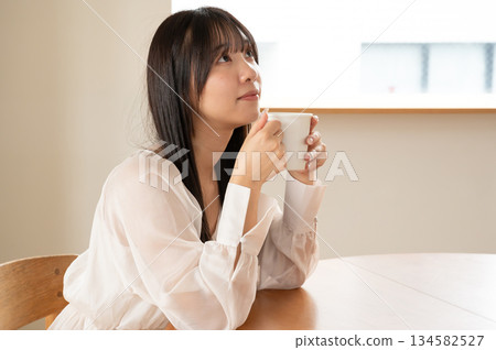 A young woman relaxing at a cafe A young woman relaxing at a cafe 134582527