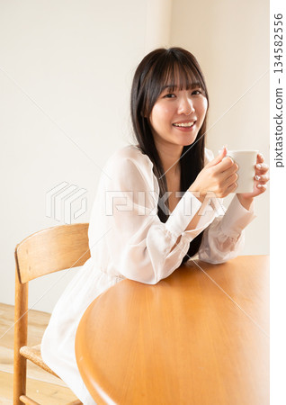 A woman drinking coffee A woman drinking coffee 134582556