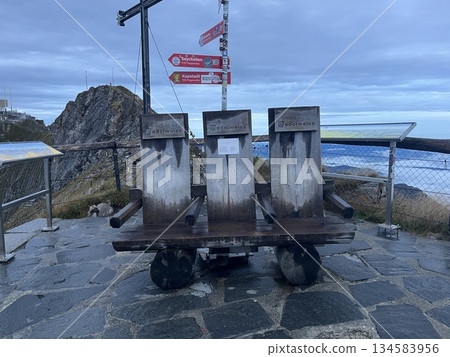 Wooden benches at Mount Pilatus Observatory in Switzerland Wooden benches at Mount Pilatus Observatory in Switzerland 134583956